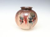 un petit vase orné d'un motif, posé sur une table