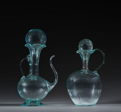 two clear glass vases sitting on top of a table