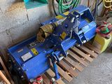 a blue machine that is sitting on a pallet in a garage