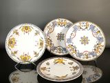 three plates are sitting on a table with a black surface