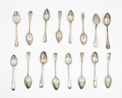 many spoons and spoon spoons laid out on a white surface