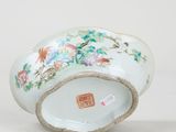 a white bowl with flowers and birds painted on it