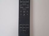 the remote control for a television is sitting on a white surface