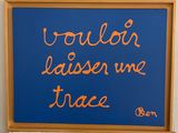 a blue sign with orange writing on it on a wall