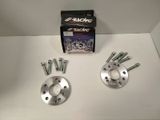 a close up of a pair of wheel spacers and bolts on a table