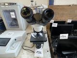 two microscopes and a laptop on a table