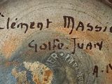 a close up of a clock on a wooden table