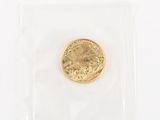 a close up of a gold coin in a clear plastic bag