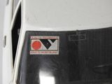 a close up of a white van with a sticker on it