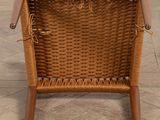 an image of a wicker chair sitting on top of a wooden floor