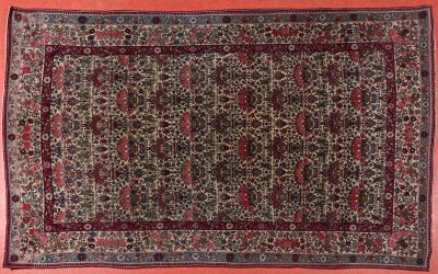 an oriental rug on a pink background with a red border