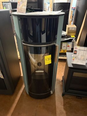 a black and silver water dispenser in the middle of a store