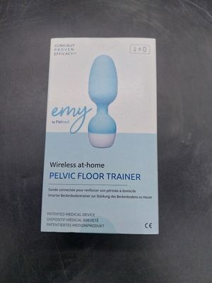 an empty box of a blue vibrating floor trainer on a table