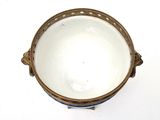 a white bowl with a gold rim sitting on a table