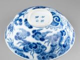 an oriental blue and white bowl with a dragon design on the lid
