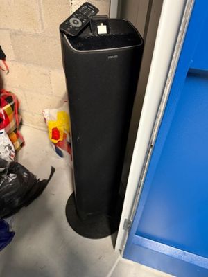 a black trash can sitting next to a blue door