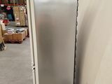 a refrigerator in the middle of a large warehouse