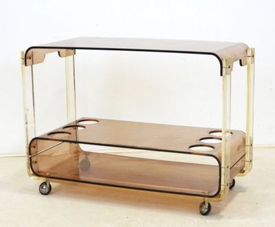a glass and brass trolley with two shelves on it