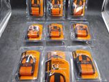 beaucoup de téléphones portables orange et noirs dans des étuis en plastique