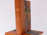 two books sitting on top of each other on a white surface