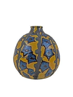 a blue and yellow vase sitting on a white surface