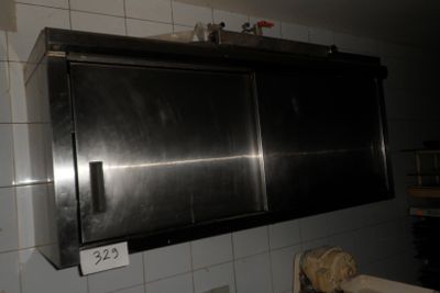 a stainless steel cabinet above a sink in a kitchen