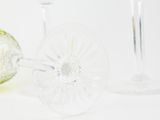 three wine glasses sitting next to each other on a table