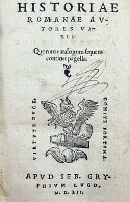 an old book with a drawing of a winged bird on it