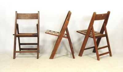 three wooden chairs sitting next to each other on the floor
