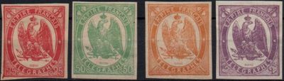 a group of four different colored stamps on a black background