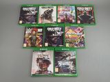 a lot of xbox game covers on the table