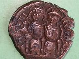 an old coin with a picture of a man and a woman on it