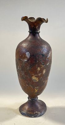 a brown vase sitting on top of a white table