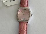 an image of a wrist watch with a pink strap and a price tag