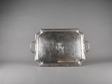 a silver tray with handles and handles on a white surface