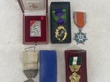 a small box of medals and other items on a table