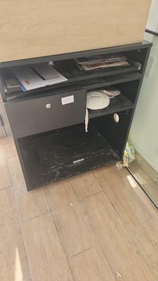 a small desk with a drawer underneath it in a room