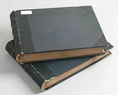 two books stacked on top of each other on a table