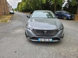 the front of a grey car parked on the side of a road