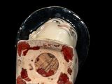 a ceramic figurine of a man with a clock on it