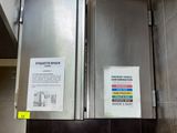 a picture of a public restroom with a sign on the wall