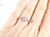 an image of a woman ' s hand with a diamond ring on it