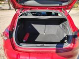a red car with its trunk open in a parking lot
