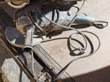 a drill on the ground next to a pair of scissors