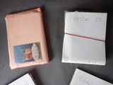 three books with writing on them sitting on a table next to each other