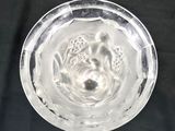 a glass bowl with water inside of it on a table