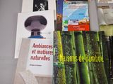 many books on a table that are sitting on top of each other