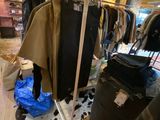a lot of clothes hanging on a rack in a store