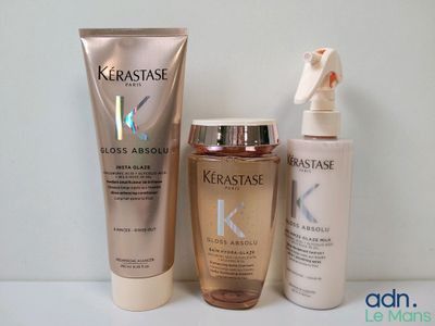 un flacon de Kérastase et un flacon de lotion placés l'un à côté de l'autre