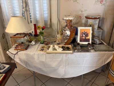 a table with a lamp and pictures on it in a room